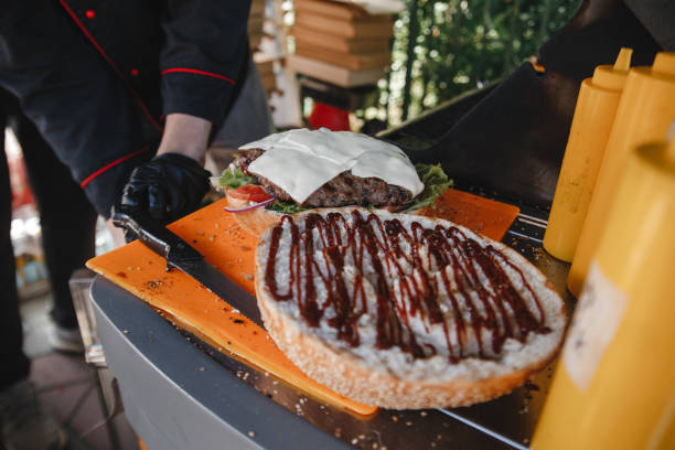 istock the cook is preparing a huge Burger 1257445754