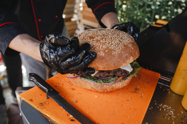 istock the cook is preparing a huge Burger 1257445766