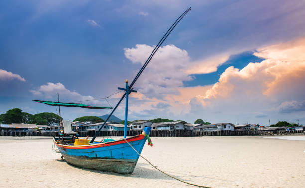 Fishery boat with sea beach  and warm lighting daylight.