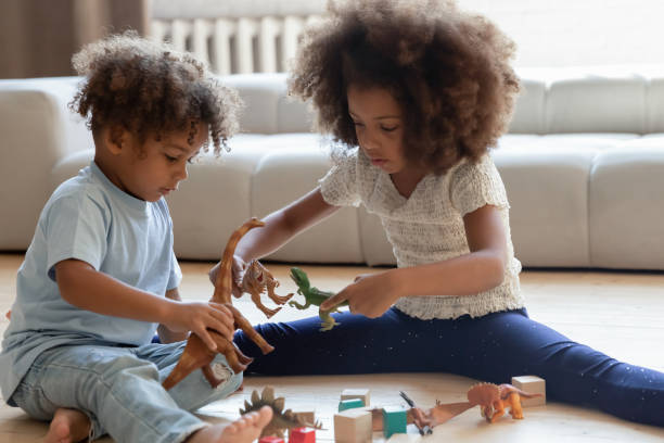 playful little biracial children play toys at home - african ethnicity brother ethnic little boys imagens e fotografias de stock