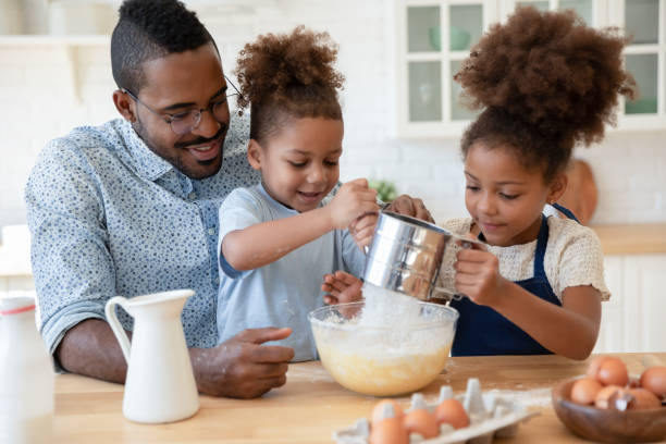 istock Caring biracial dad and little kids making pancakes 1257454221