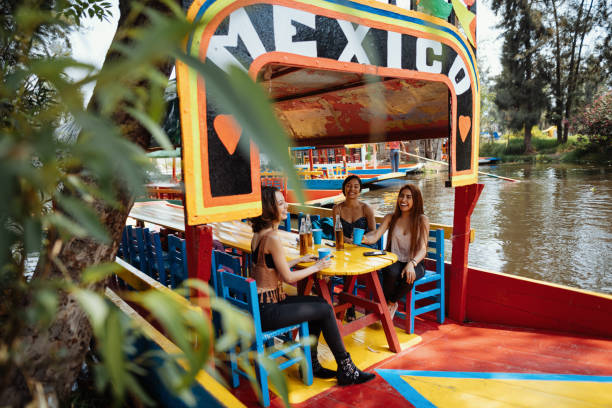 Latin travelers on city break enjoying boat ride Young women driving in car - sharing a ride to work or going for a road trip together. mexico city stock pictures, royalty-free photos & images