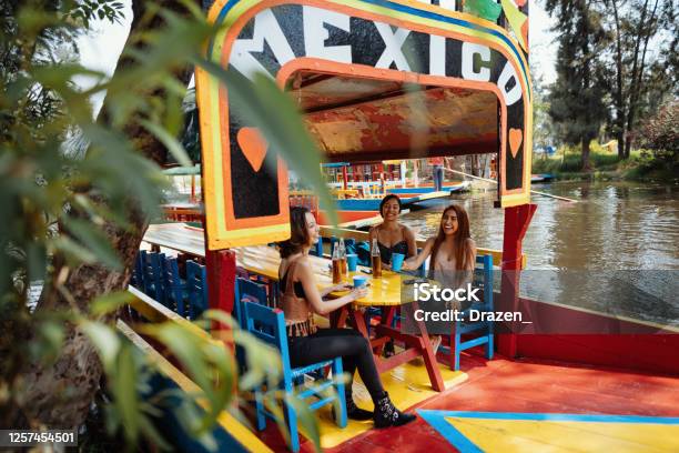 Latin Travelers On City Break Enjoying Boat Ride Stock Photo - Download Image Now - Xochimilco Gardens, Travel, Tourist