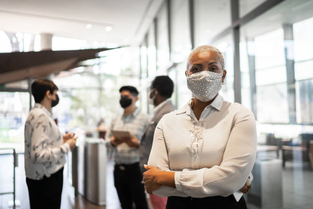 Portrait of businesswoman at work with face mask Portrait of businesswoman at work with face mask new normal concept stock pictures, royalty-free photos & images
