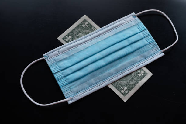 istock Cost of prevention corona virus - dollar and facemask 1257456593