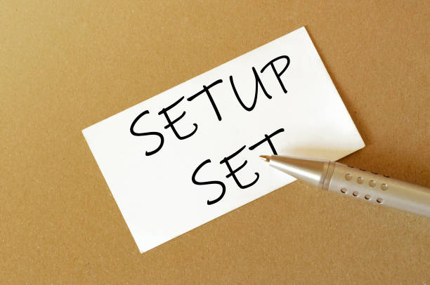 istock pen, white paper with text Setup Set on the brown background 1257460503