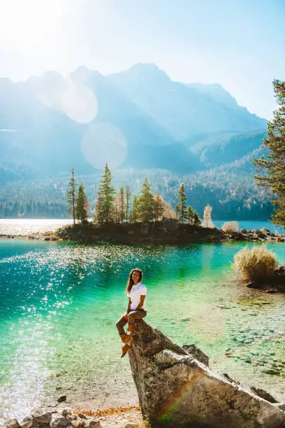 Digital Detox – Young woman enjoying nature in the mountains at Eibsee, Garmisch-Partenkirchen, Germany