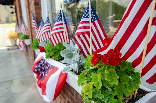 The American Dream is pictured in this iconic image of American Flags and bunting decorations placed in a shop window.