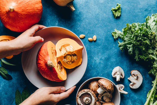 istock Woman cooking a dish with pumpkin in kitchen 1257464391
