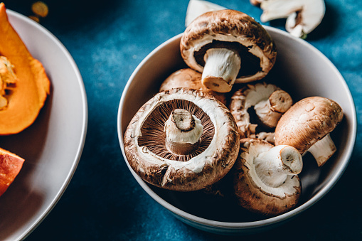 Close-up of edible mushrooms in a bowl. Fresh mushrooms for cooking in kitchen.
