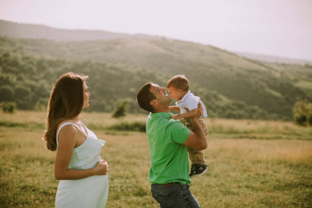 istock Young family having fun outdoors in the field 1257466635