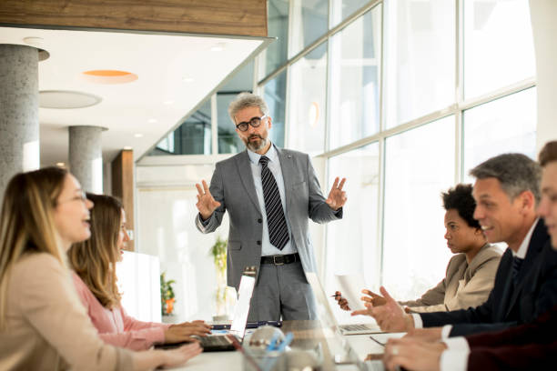 istock Mature businessman explaining strategy to group of multiethnic business people while working on new project 1257468016