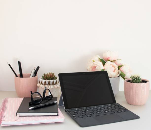 istock Home office laptop potted plants and pink notebook 1257468590