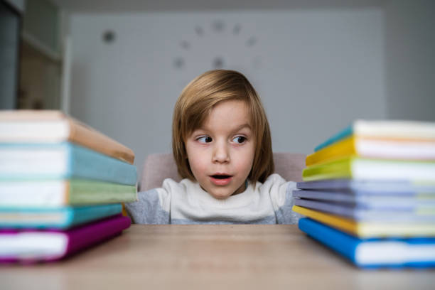 istock Little boy with books at home 1257470103