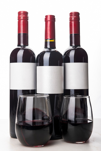 bottles with variety of wines, on white background