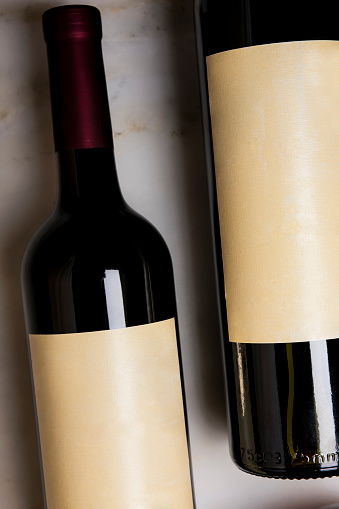 Red wine bottles stored in a wine cellar of a winery