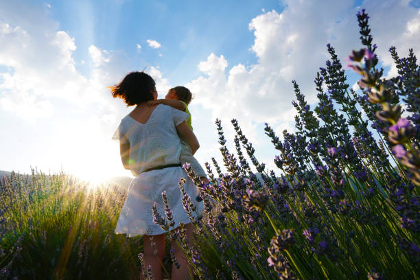 istock young mother and son walking in lavender field 1257472213