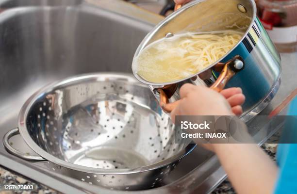 Draining The Water From The Spaghetti Stock Photo - Download Image Now - Pasta, Water, Cooking
