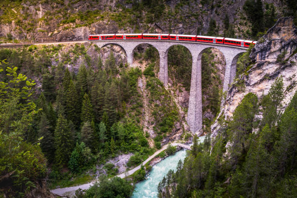 train crossing landwasser viaduct on raethian railway in filisur - albula, graubunden, switzerland - engadine european alps switzerland water photos et images de collection