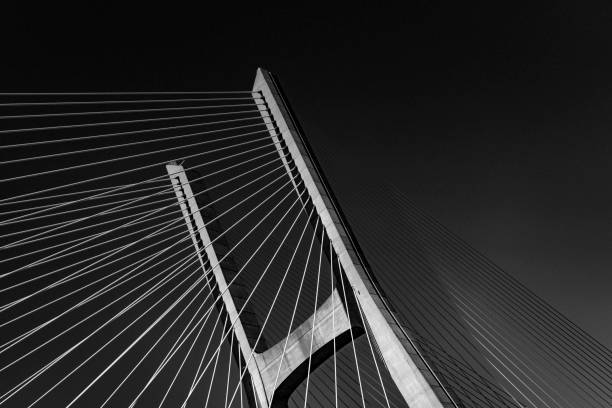 Vasco da Gama Bridge landscape view detail in black and white photography Vasco da Gama Bridge landscape view detail in black and white background wallpaper image photography by tagus river, Lisbon, Portugal steel cable photos stock pictures, royalty-free photos & images