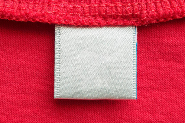 istock White blank laundry care clothes label on red cotton shirt background 1257482786