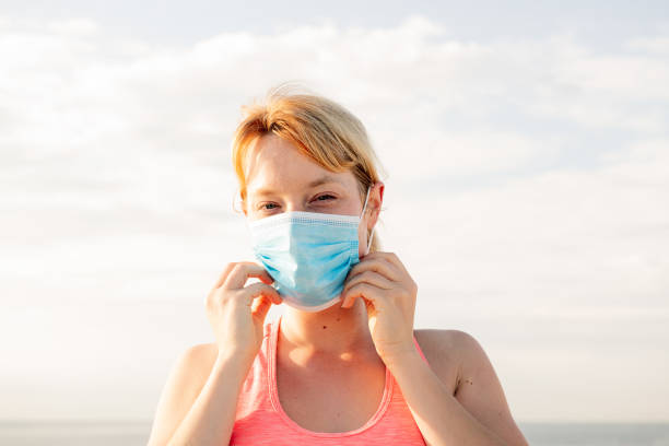 istock beautiful blonde woman wearing a protective mask 1257482912