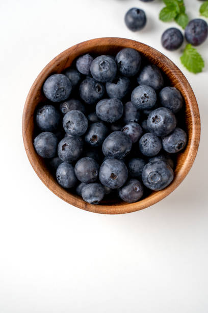 istock Blueberry fruit top view isolated on a white background, flat lay overhead layout with mint leaf, healthy design concept. 1257484771