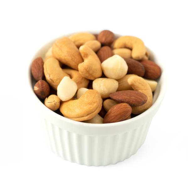istock Nuts in circle shaped ceramic bowls isolated on white background. Various nuts (almonds, macadamia, cashew, peanuts). Mix nut healthy ingredients food. 1257487702