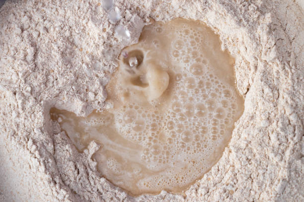 istock Wheat flour with water to make dough, close up 1257489757