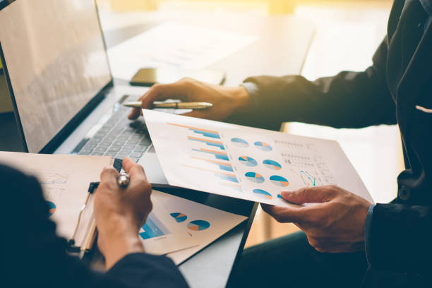 istock Businessman analysis on Graph data paper  using calculator, finance concept in office. 1257490437