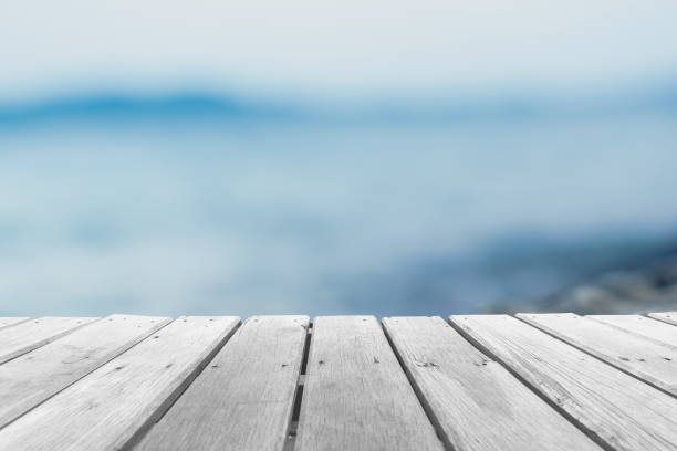 istock Selective focus of old wood table with blur beautiful beach background for display your product. 1257496913