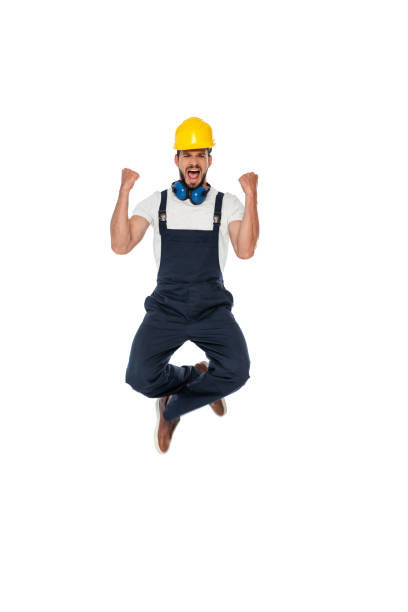 istock Excited builder in uniform showing yeah gesture isolated on white 1257500491