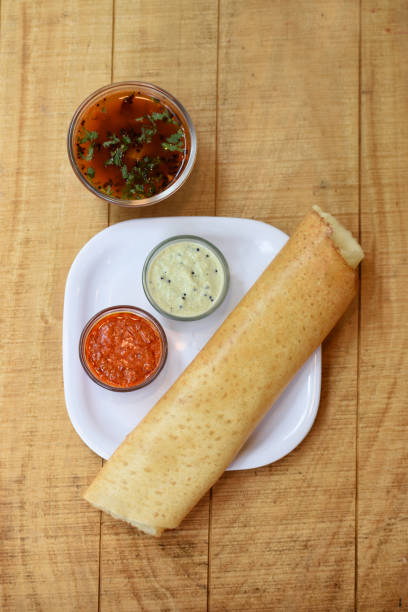Masala dosa , South Indian meal served with sambhar and coconut chutney over,Traditional South Indian rice Dosa , Indian food,Selective focus Masala dosa , South Indian meal served with sambhar and coconut chutney over,Traditional South Indian rice Dosa , Indian food,Selective focus thosai stock pictures, royalty-free photos & images
