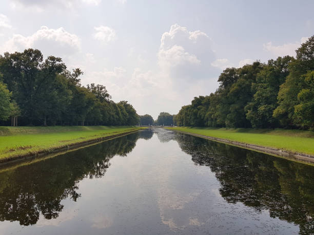 istock Forest and sky reflected in a water smooth surface of lake, Munich, Germany 1257510910