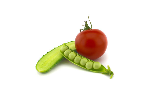 istock Red ripe tomato, peas in a pod and cucumber 1257511784