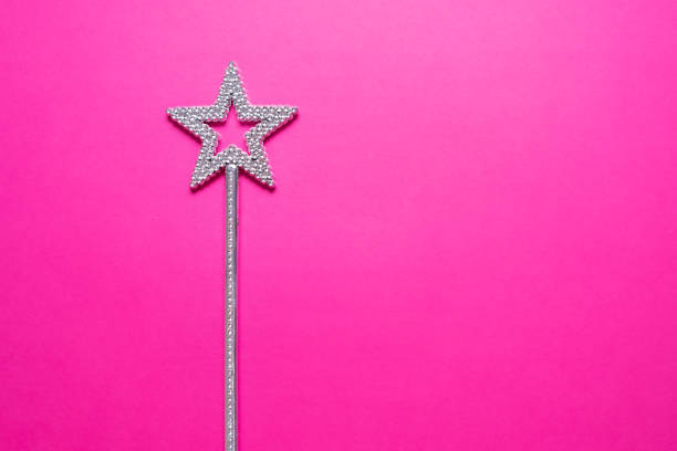 istock Sparkling magic wand on a pink background. Concept of celebration and magic, copy space 1257517719
