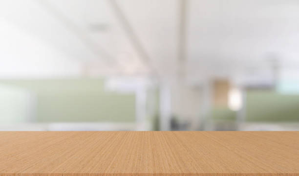 istock abstract blur inside office with modern wood table perspective for show ads or promote product and content on display concept 1257522686
