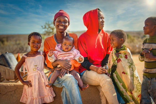 子供とティーンエイジャーのアフリカの家族グループ - africa child village smiling ストックフォトと画像