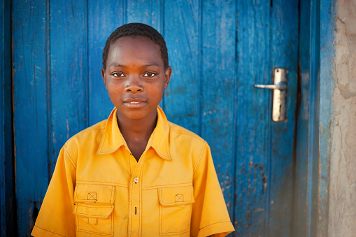 African child, with yellow shirt, in a village in Botswana