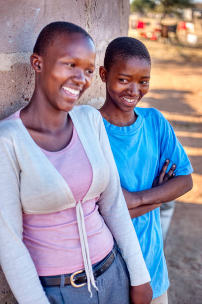 istock two african sisters posing in front of their house 1257529713