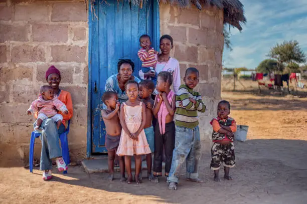 Family life group of African kids and mother in a village in Botswana
