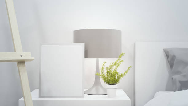 istock Plant in flower pot near empty picture frame and bed. 1257530814