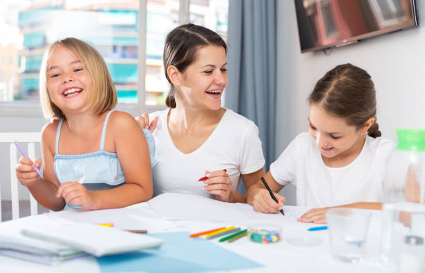 istock Mother and two children together with wax crayons 1257531192
