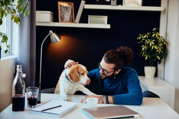 istock Young attractive engineer sitting in his office and drawing windmill model. Sustainable development concept. 1257532023