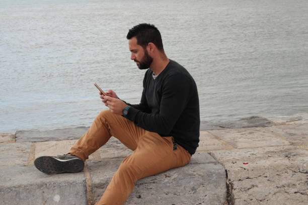 istock Distracted man by the river, Lisbon, Portugal 1257534358