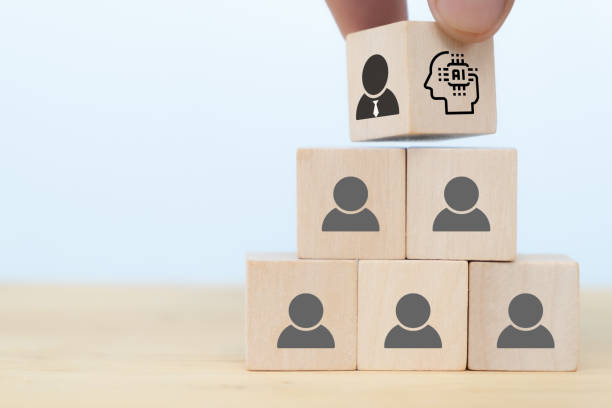 istock business man hand arranging wooden cube block from human intelligence which control the human resources management to artificial intelligence. the job will be replaced by AI in the near future concept 1257534692