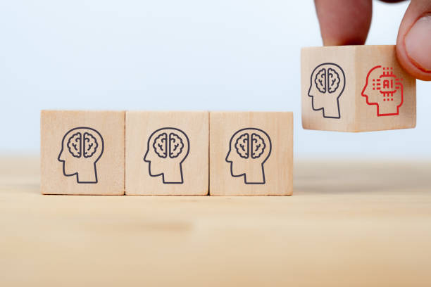 istock business man hand arranging wooden cube block from human intelligence to artificial intelligence. the job will be replaced by AI in the near future concept 1257534695