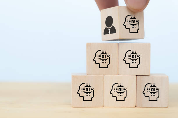 istock business man hand arranging wooden cube block from human intelligence which control the machine or robot to artificial intelligence. the job will be replaced by AI in the near future concept 1257534696