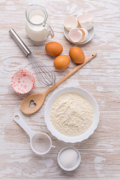 istock Assortment of basic baking ingredients for cake or pancakes on wooden background 1257536426