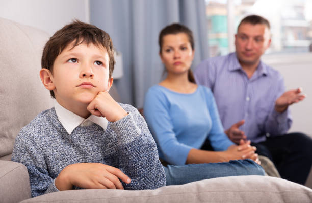 istock Upset boy scolded by mother and father 1257537523